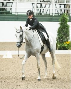 Dressage rider patting horse
