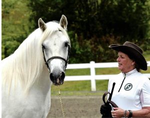 Woman standing next to pony