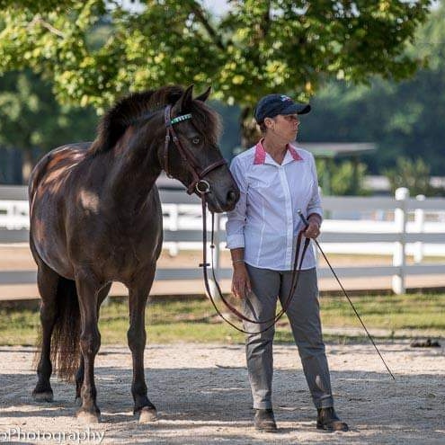 Woman standing next to horse